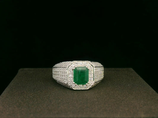 18K white gold men’s ring with emerald-cut green gemstone and diamond halo.