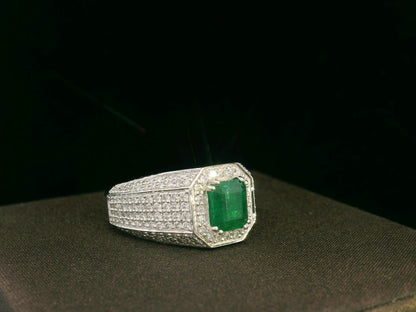 18K white gold men’s ring with emerald-cut emerald and diamond halo.