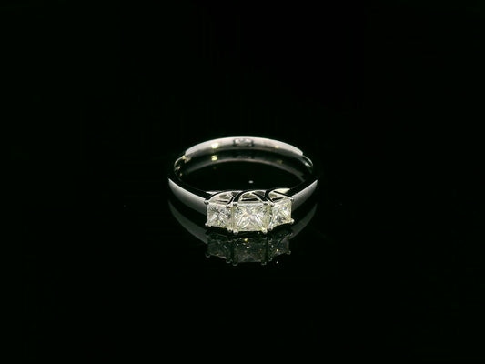 18k white gold trilogy ring with three princess-cut diamonds, total 0.66 ct, modern classic design.
