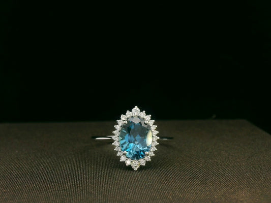 18k white gold London Blue Topaz and diamond halo ring