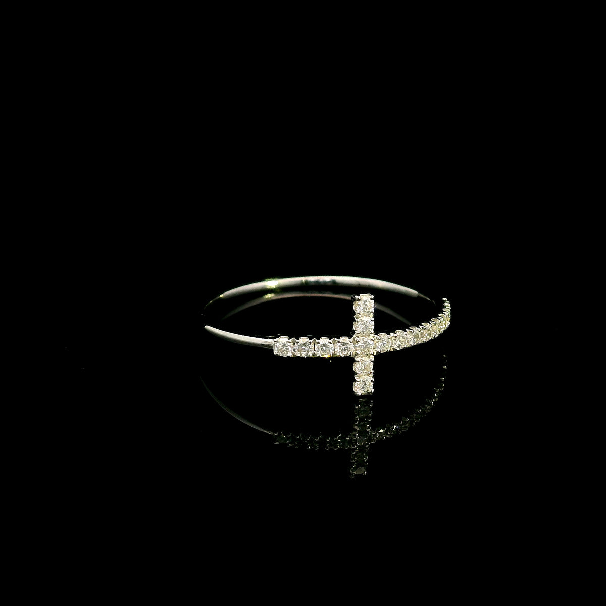 Diamond cross ring in 18K white gold featuring round brilliant diamonds set across the cross and along the slender band.