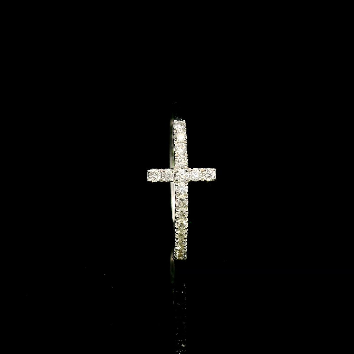 Diamond cross ring in 18K white gold featuring round brilliant diamonds set across the cross and along the slender band.