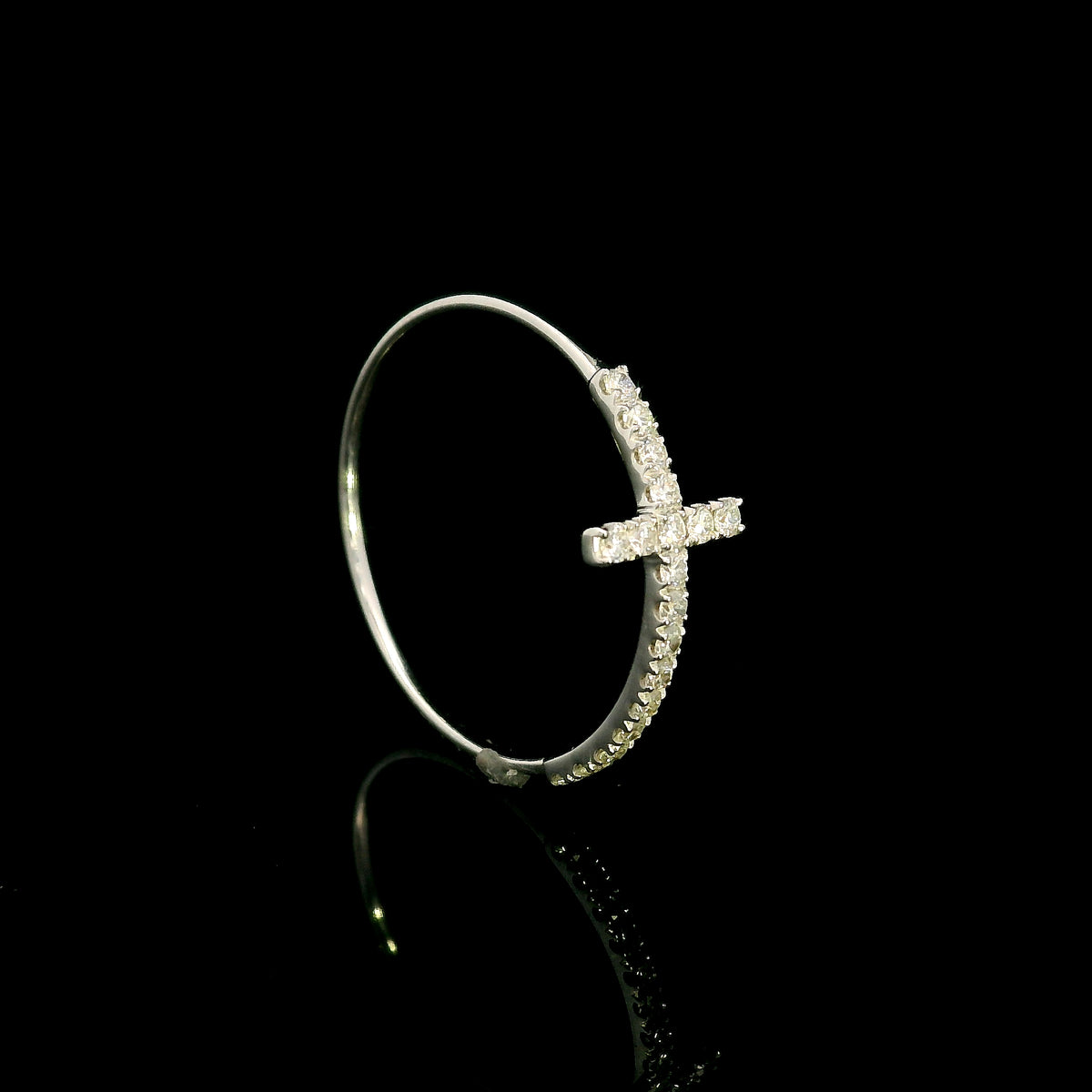 Diamond cross ring in 18K white gold featuring round brilliant diamonds set across the cross and along the slender band.