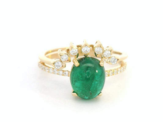 Front view of 18k yellow gold emerald engagement ring with matching diamond wedding band