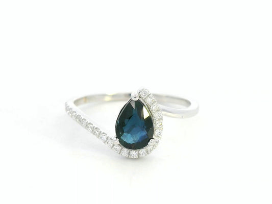 Front view of 18k white gold ring with 0.90 ct pear-shaped blue sapphire and 0.14 ct diamonds in bypass design