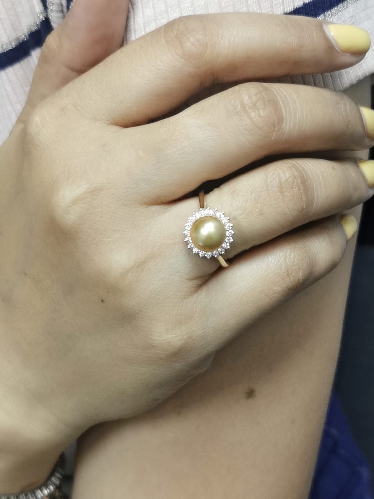 Ring on finger showcasing opulent pearl and diamond combination