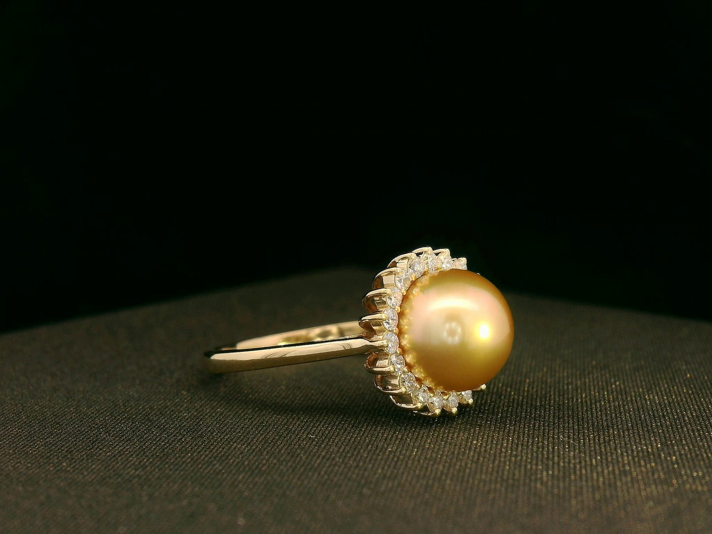 Side view highlighting pearl centerpiece and sparkling diamond halo