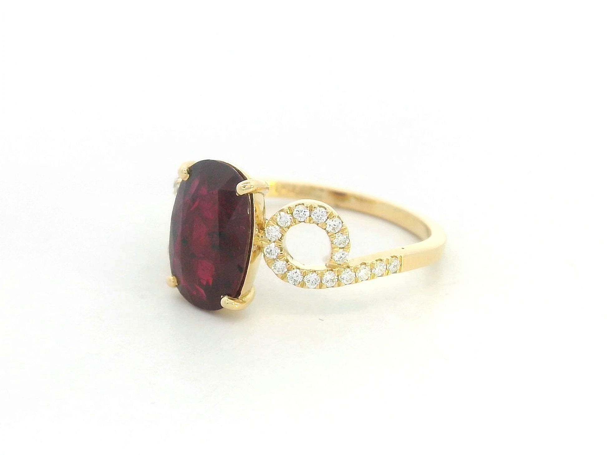 Angled view highlighting prong-set ruby and decorative diamond shoulders