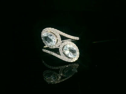 Front view of 18k white gold ring with two oval aquamarines and 0.39 ct diamond halos
