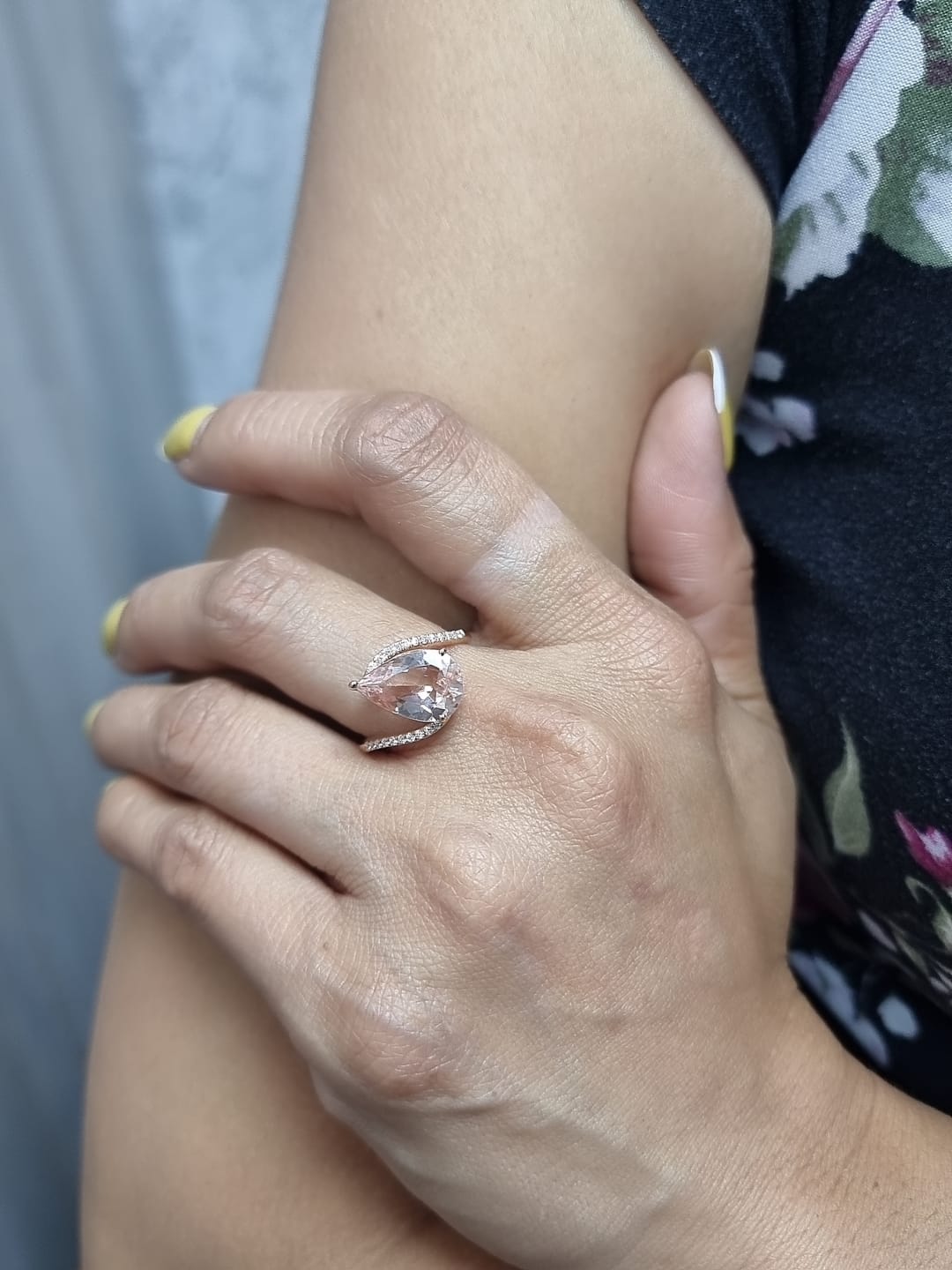Ring on finger showcasing soft pink morganite and dazzling diamonds
