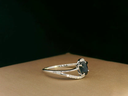 18k white gold ring with 0.63ct oval sapphire & 0.08ct diamond swirl – certificate included