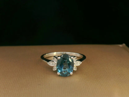 18k white gold ring with 2.35ct oval London Blue Topaz and 0.04ct diamond floral accents – certificate included