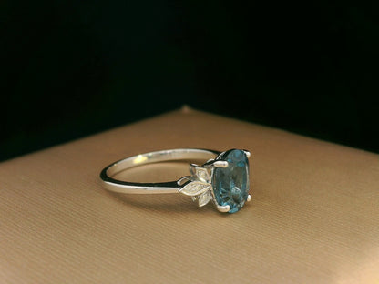 18k white gold ring with 2.35ct oval London Blue Topaz and 0.04ct diamond floral accents – certificate included