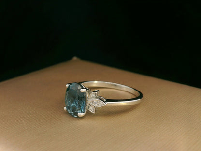 18k white gold ring with 2.35ct oval London Blue Topaz and 0.04ct diamond floral accents – certificate included