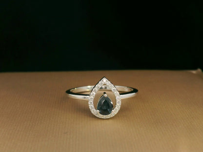 18k white gold ring with 0.41ct pear-cut blue sapphire and 0.11ct open diamond halo – certificate included