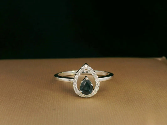 18k white gold ring with 0.41ct pear-cut blue sapphire and 0.11ct open diamond halo – certificate included