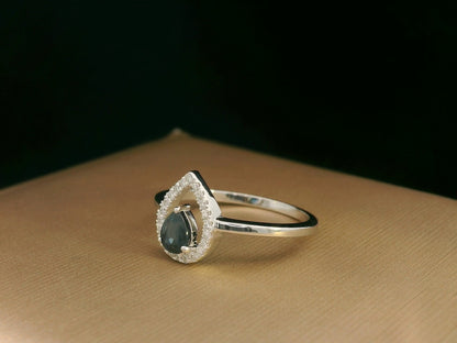 18k white gold ring with 0.41ct pear-cut blue sapphire and 0.11ct open diamond halo – certificate included