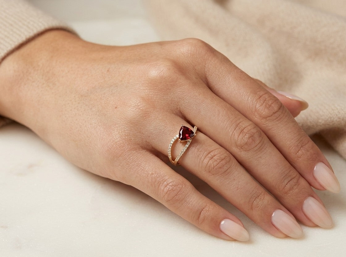 Trillion garnet and diamond crossover ring in 18K yellow gold with sweeping round diamond-set bands