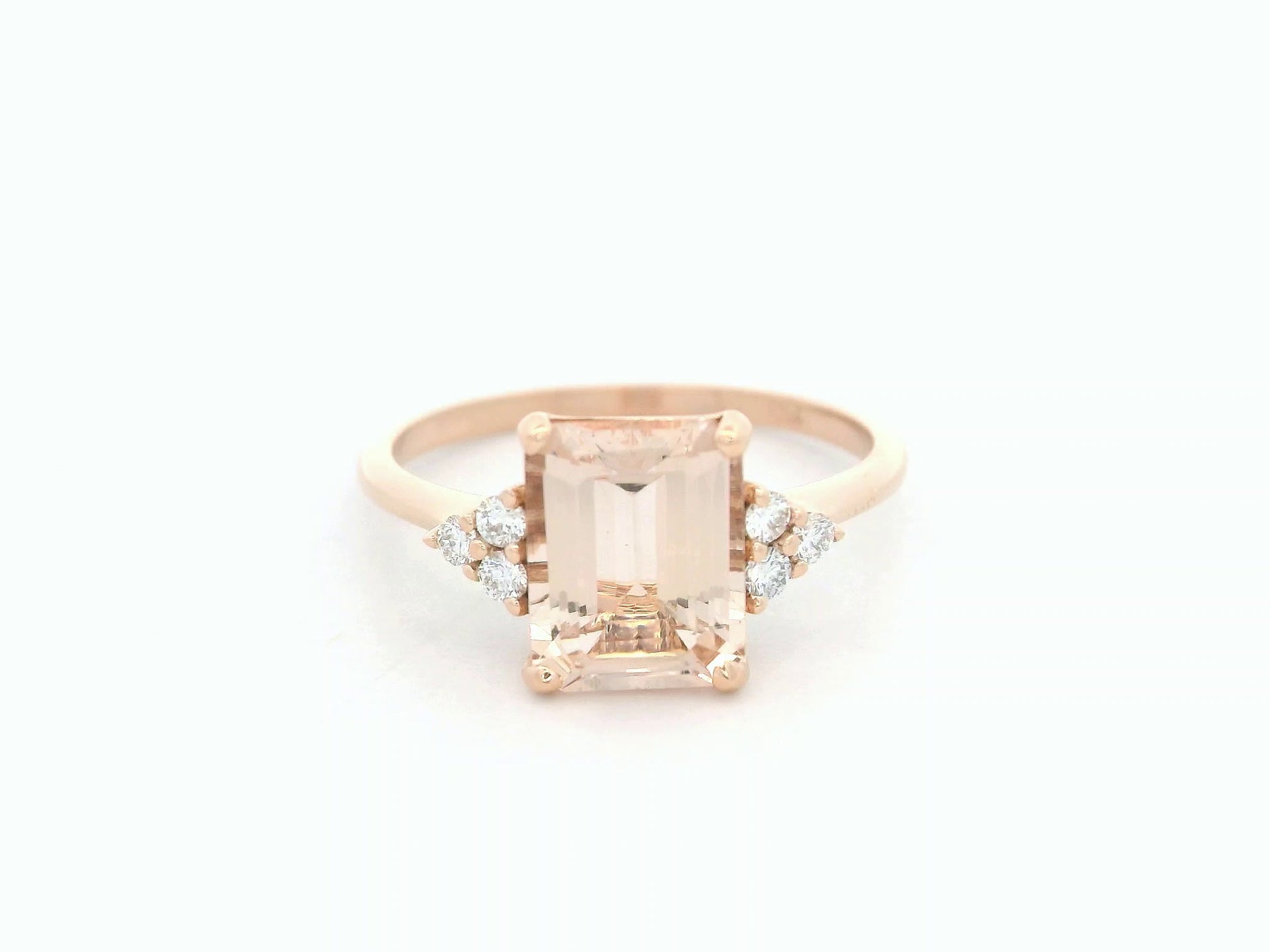18K rose gold ring featuring a 1.80ct emerald-cut Morganite with diamond clusters on each side.