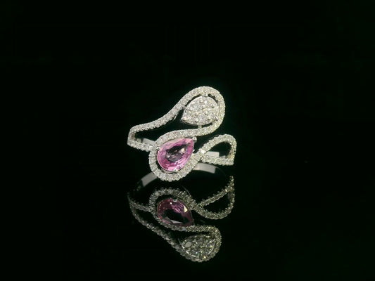 18k white gold ring with 0.74ct pear-shaped pink sapphire and 0.59ct diamonds in a sculptural double-drop design.