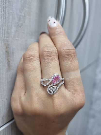18k white gold ring with 0.74ct pear-shaped pink sapphire and 0.59ct diamonds in a sculptural double-drop design.