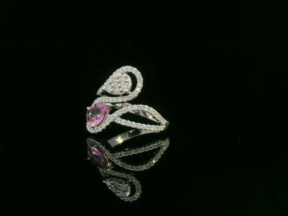 18k white gold ring with 0.74ct pear-shaped pink sapphire and 0.59ct diamonds in a sculptural double-drop design.