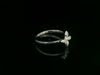 18k gold ring featuring a floral motif with four marquise-shaped diamonds forming a cross, set on a slim minimalist band for modern elegance