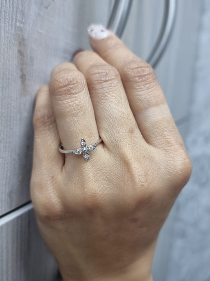 18k gold ring featuring a floral motif with four marquise-shaped diamonds forming a cross, set on a slim minimalist band for modern elegance