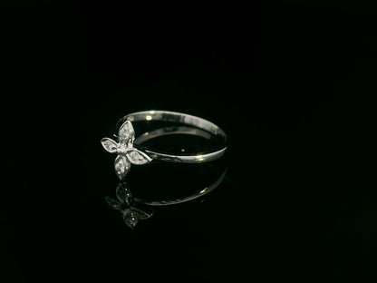 18k gold ring featuring a floral motif with four marquise-shaped diamonds forming a cross, set on a slim minimalist band for modern elegance