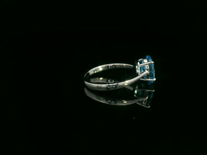 18K white gold ring featuring a 2.24ct oval-cut Blue Topaz prong-set centerpiece.