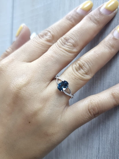18K white gold ring featuring a 1.58ct London Blue Topaz with 0.11ct diamonds set along a twisted split-shank band.
