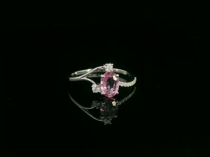 18K white gold ring featuring a 0.75ct oval Pink Sapphire with 0.12ct diamonds on an asymmetric split band.