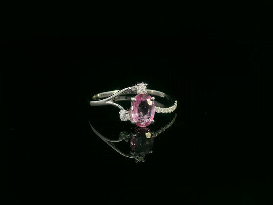 18K white gold ring featuring a 0.75ct oval Pink Sapphire with 0.12ct diamonds on an asymmetric split band.