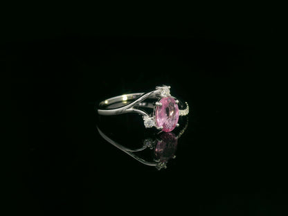 18K white gold ring featuring a 0.75ct oval Pink Sapphire with 0.12ct diamonds on an asymmetric split band.