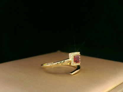 18K yellow gold ring featuring a 0.36ct square-cut ruby with 0.08ct diamonds in a halo setting on a contemporary open-bypass band.