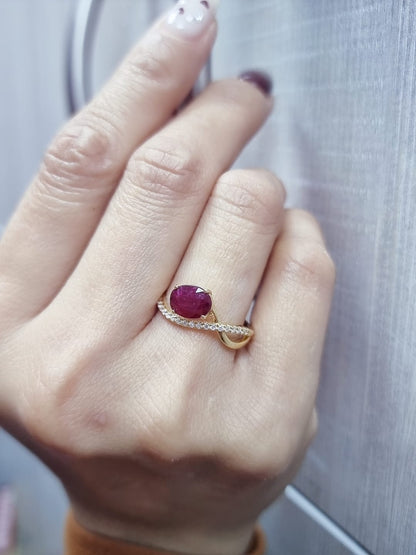 18K yellow gold oval ruby bypass ring with round diamond accents, modern luxury design