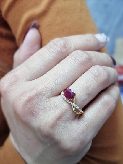 18K yellow gold oval ruby bypass ring with round diamond accents, modern luxury design