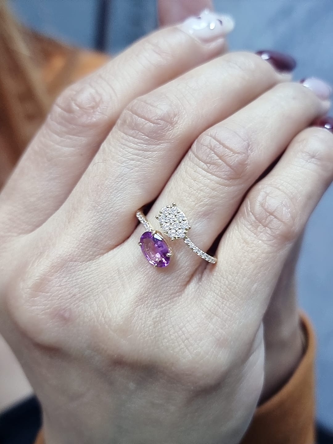 18K yellow gold oval rhodolite garnet bypass ring with pavé diamond accents, modern luxury design