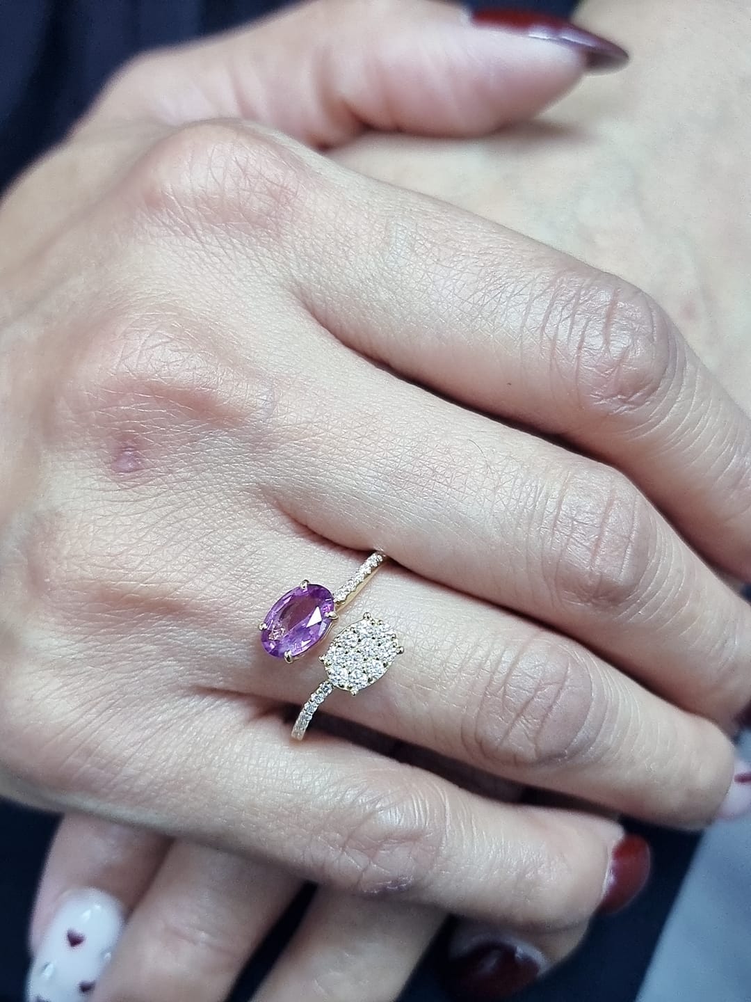 18K yellow gold oval rhodolite garnet bypass ring with pavé diamond accents, modern luxury design