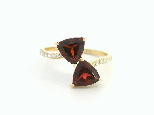 18K yellow gold open bypass ring with trillion-cut garnets and pavé diamonds, modern luxury design