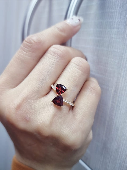 18K yellow gold open bypass ring with trillion-cut garnets and pavé diamonds, modern luxury design