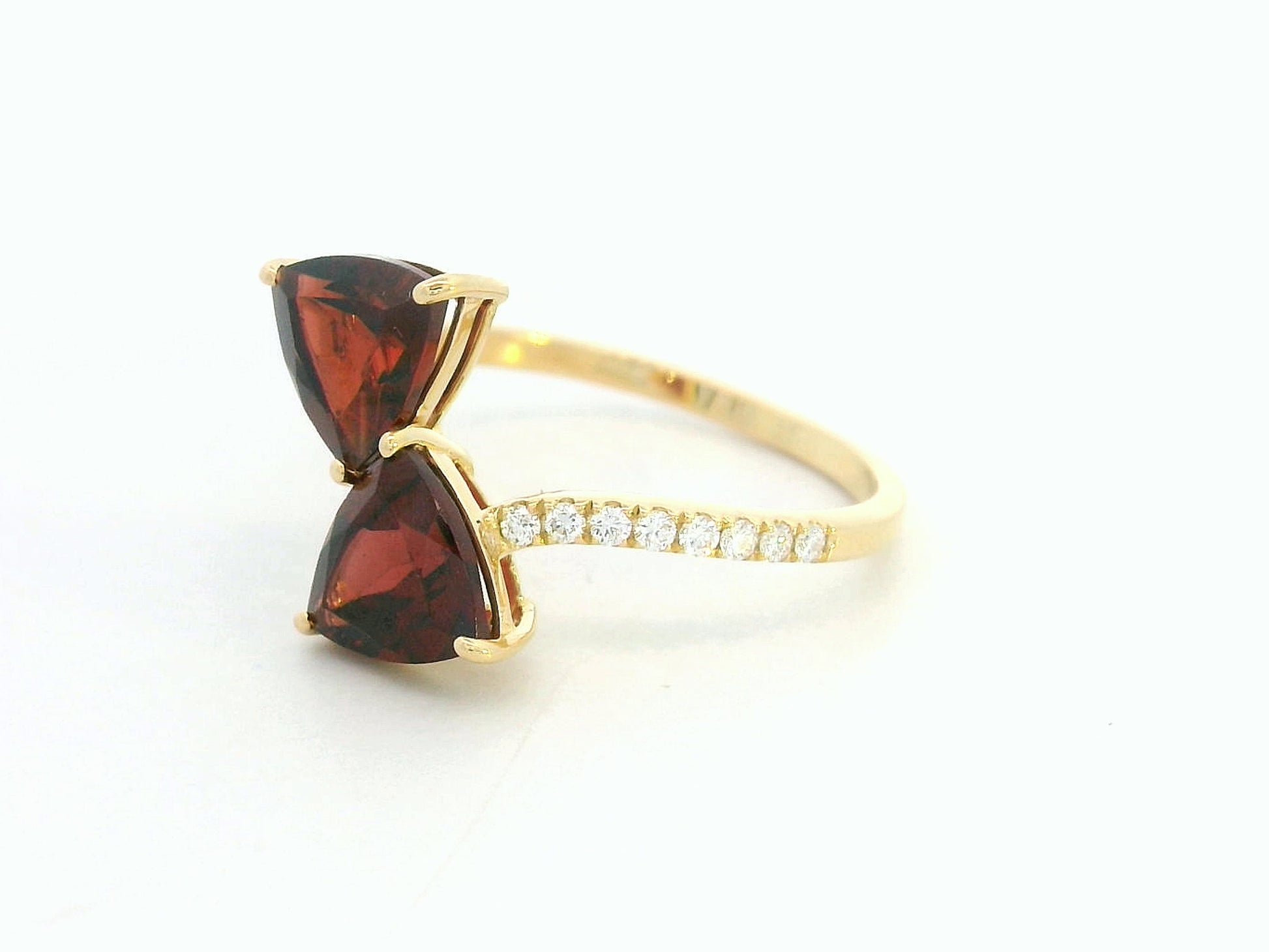18K yellow gold open bypass ring with trillion-cut garnets and pavé diamonds, modern luxury design
