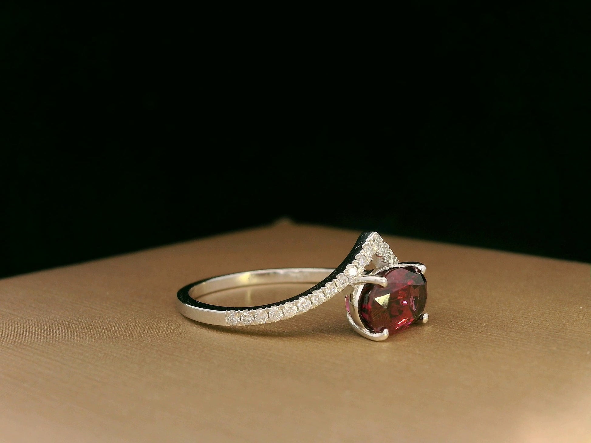 18K gold wishbone ring with oval rhodolite garnet and pavé diamonds, modern luxury design