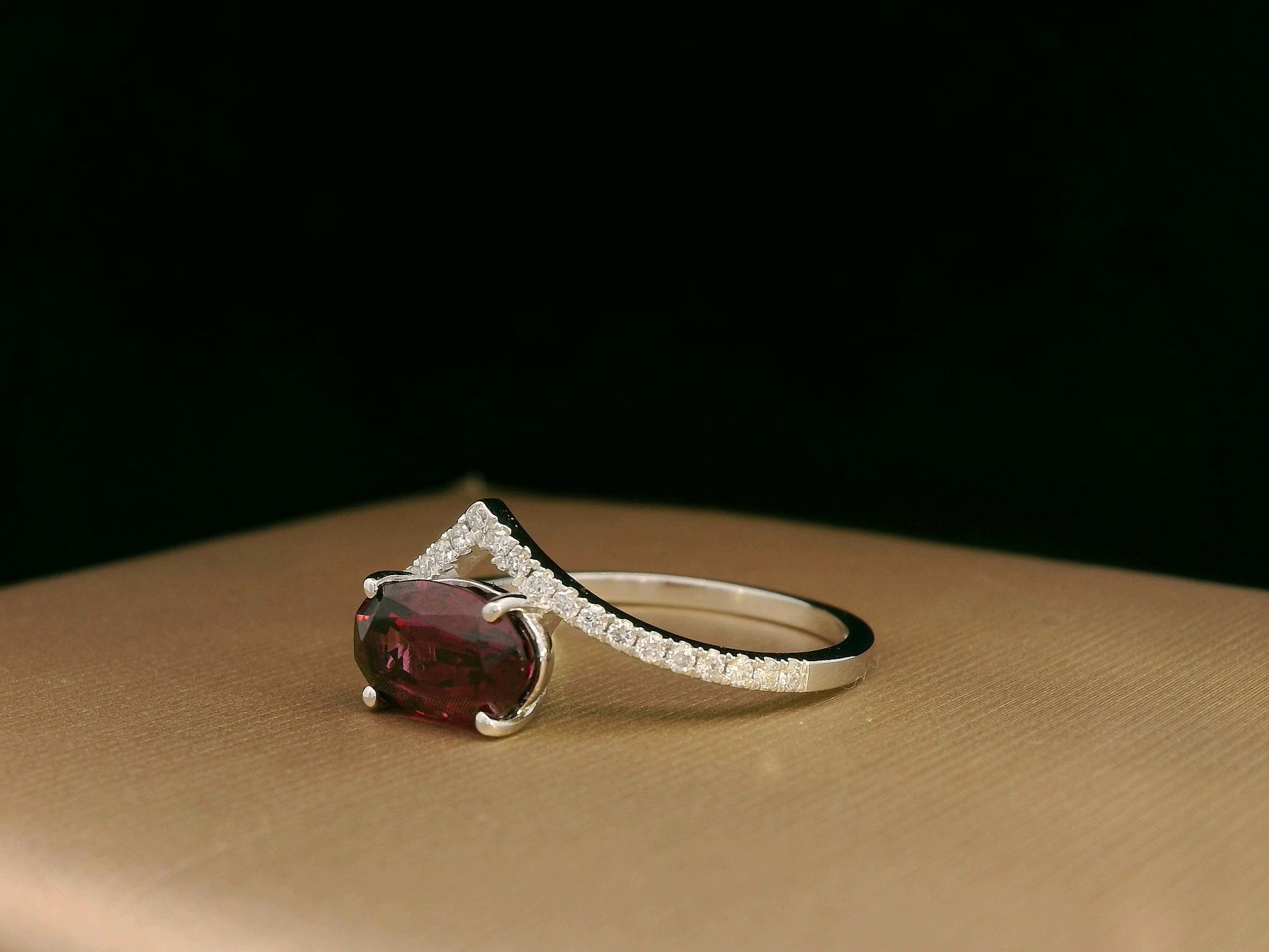 18K gold wishbone ring with oval rhodolite garnet and pavé diamonds