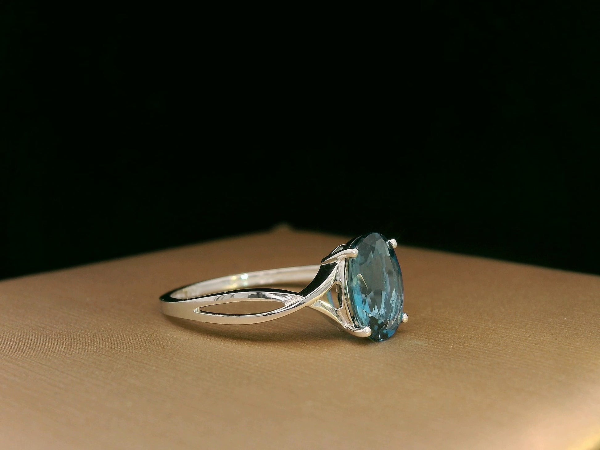 18K white gold bypass ring with 1.86 carat oval London Blue Topaz, elegant statement design