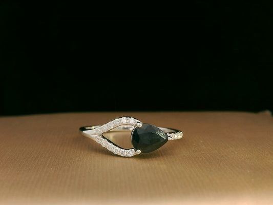 18K white gold asymmetrical ring with 0.78 carat pear-shaped blue sapphire and pavé diamonds, elegant contemporary design