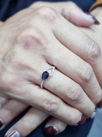 18K white gold asymmetrical ring with 0.78 carat pear-shaped blue sapphire and pavé diamonds, elegant contemporary design