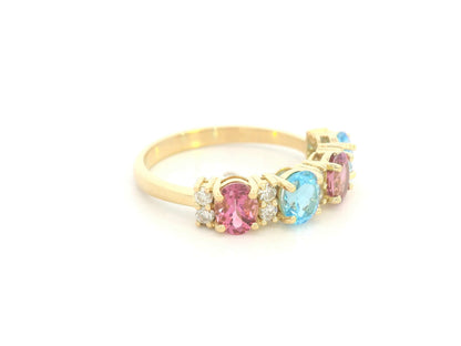 18K yellow gold band with alternating oval pink and blue sapphires and round diamond accents