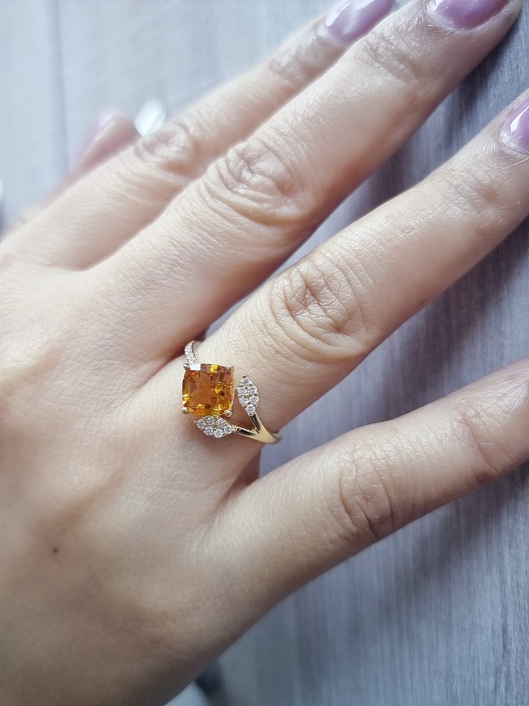18K yellow gold ring featuring a 1.33ct cushion citrine with diamond leaf design, nature-inspired luxury style.