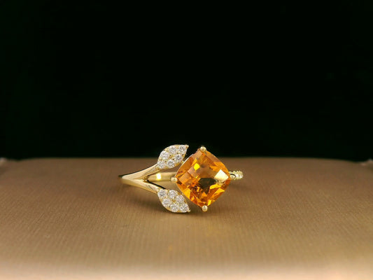 18K yellow gold ring featuring a 1.33ct cushion citrine with diamond leaf design, nature-inspired luxury style.